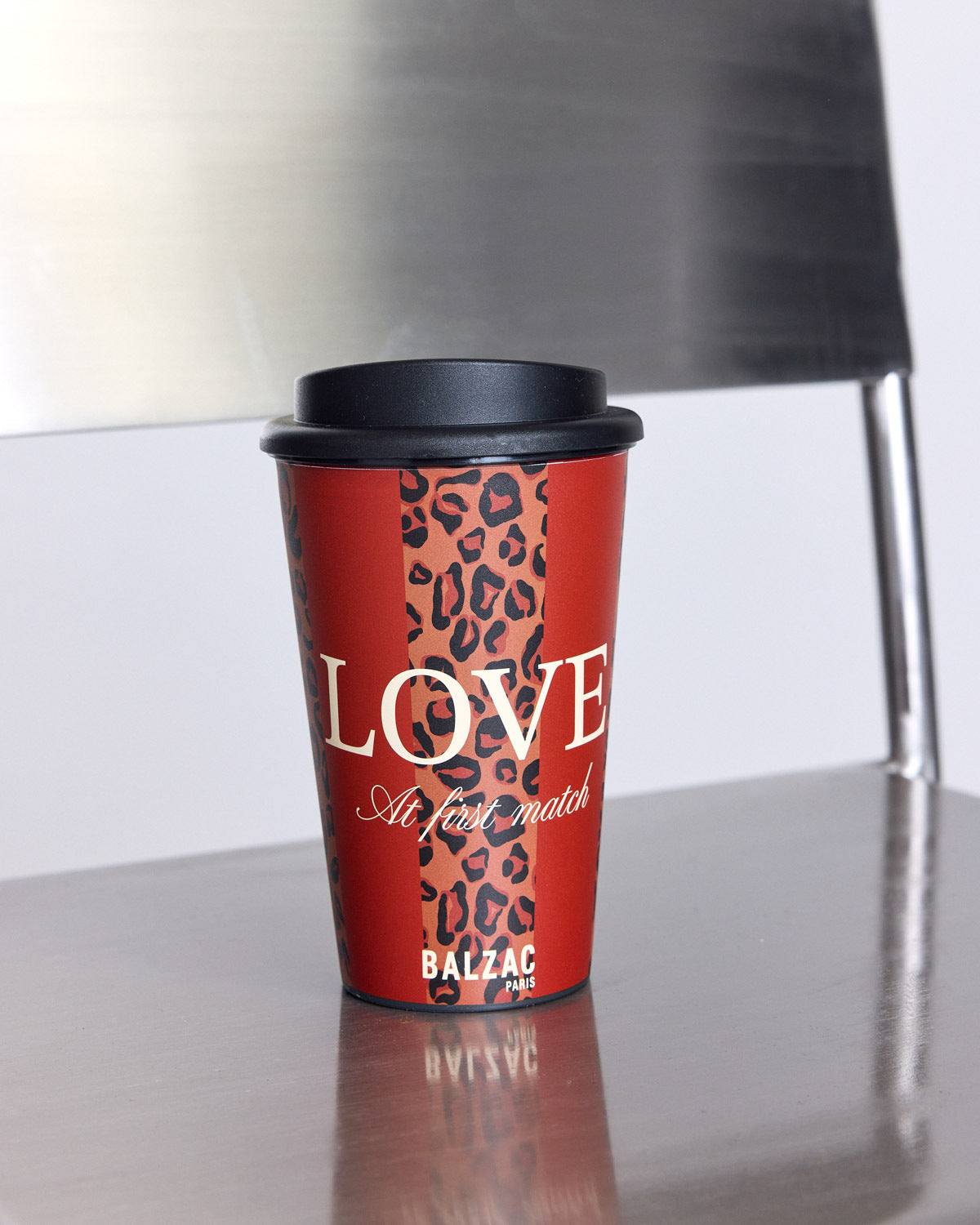 Travel mug with red and leopard stripes